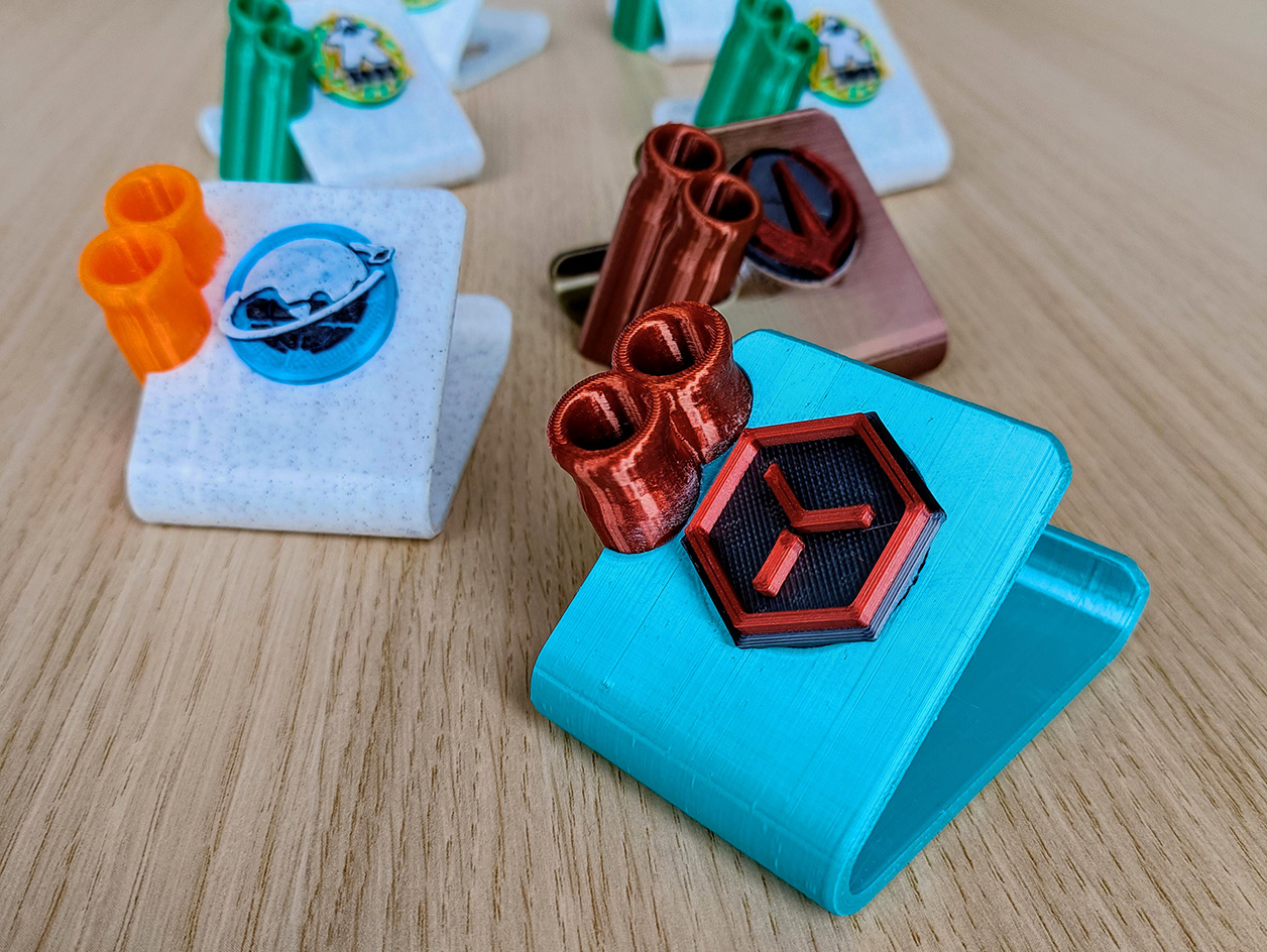 Phone stand with pen holder and emblems