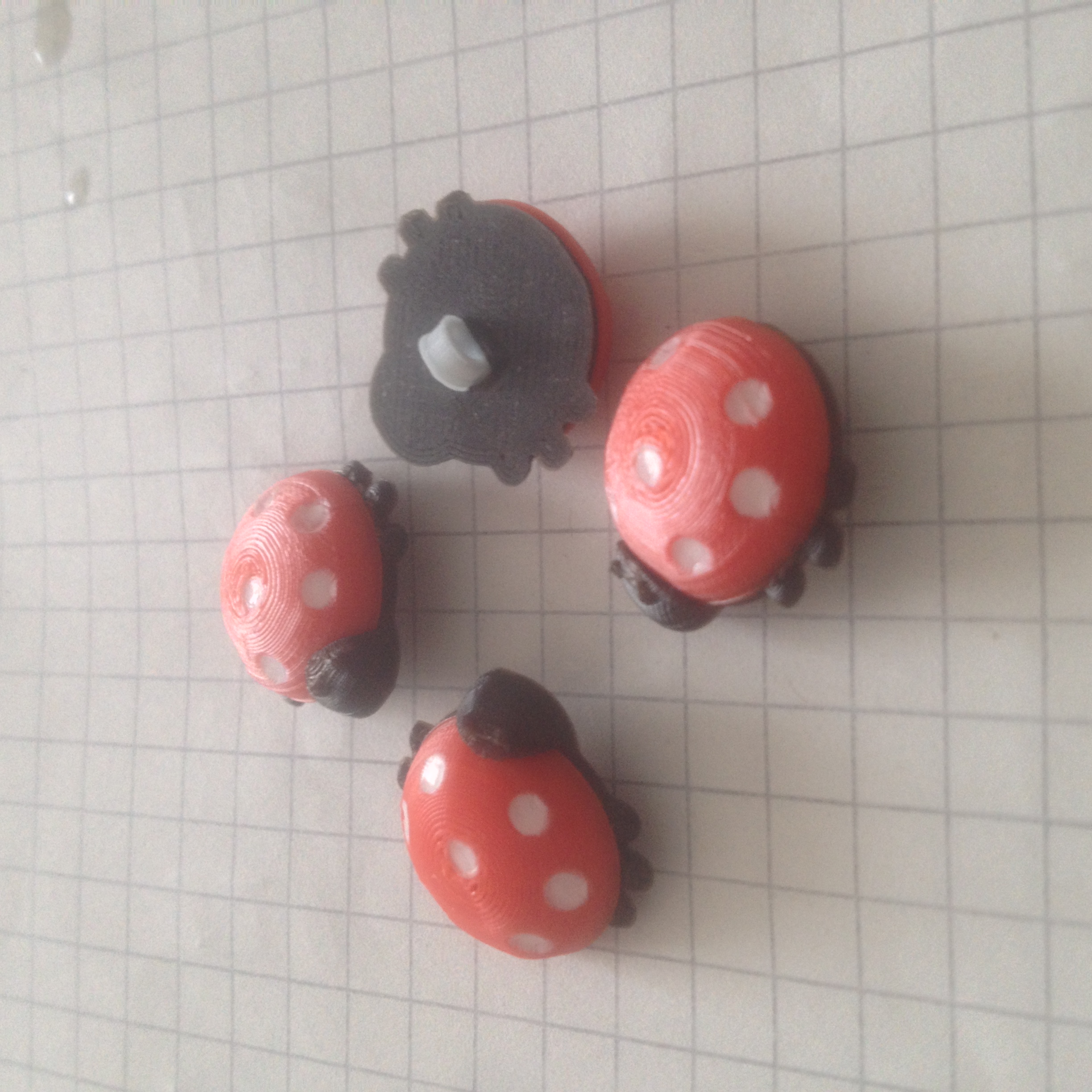Children's buttons in the shape of ladybugs.