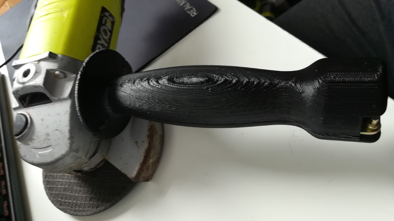 Angle grinder handle with spanner storage