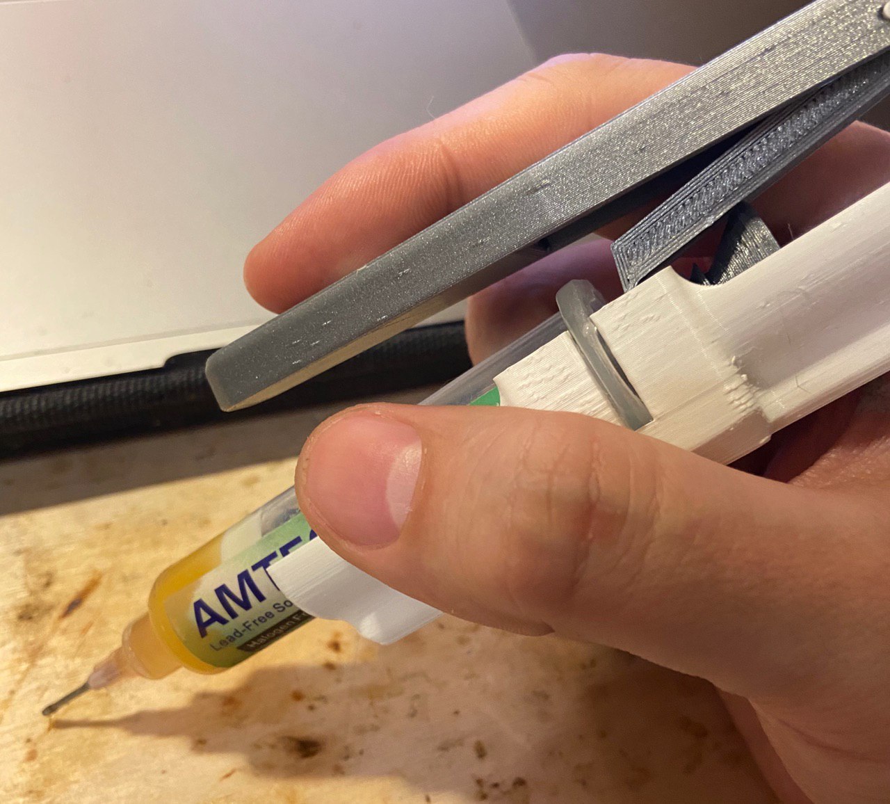 Dispenser for syringe of flux or solder paste