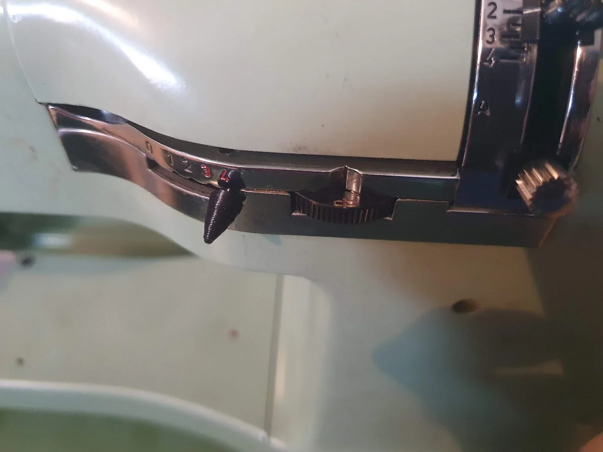 Elna supermatic stitch width knob