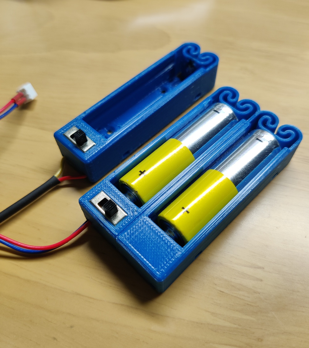 Flexing battery holders with switch and push to pop