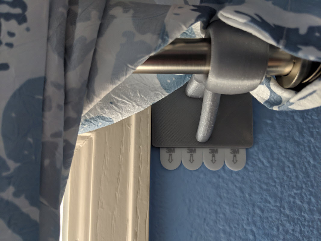 Damage free curtain rod hanger