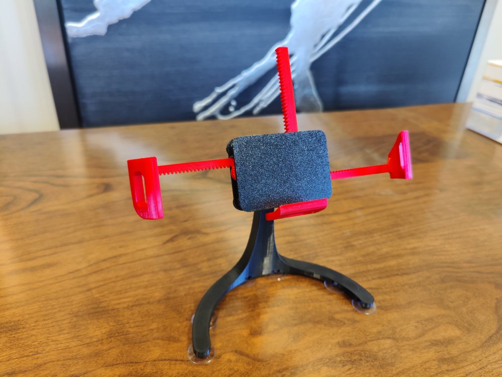 Phone-grabbing phone stand for landscape or portrait