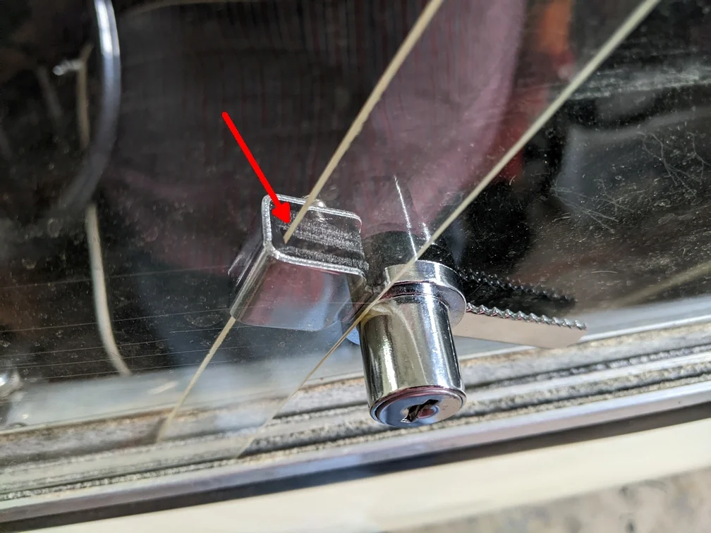 Pad for display case locks used with British sports car side screens