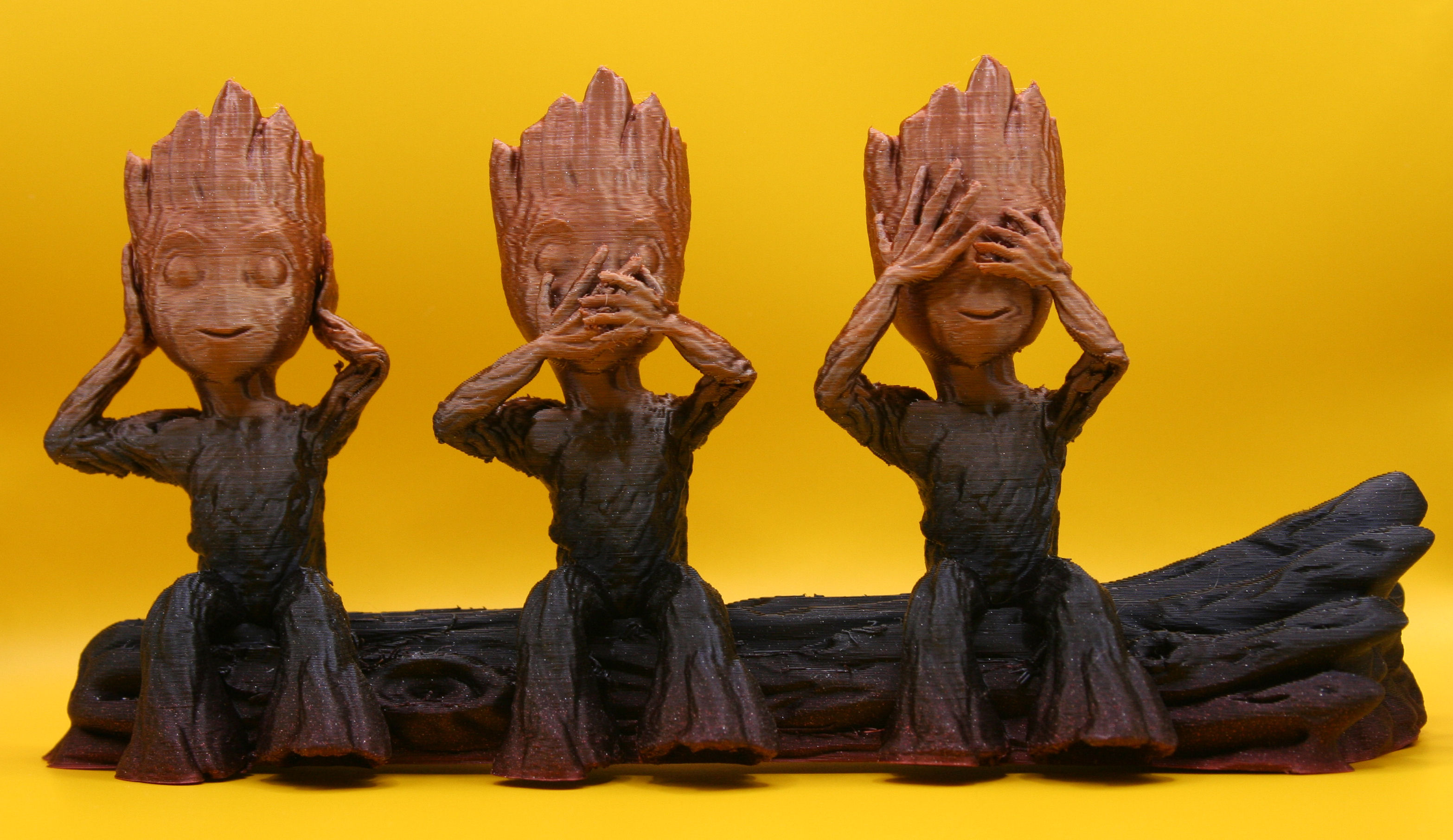 three baby groot on a tree branch
