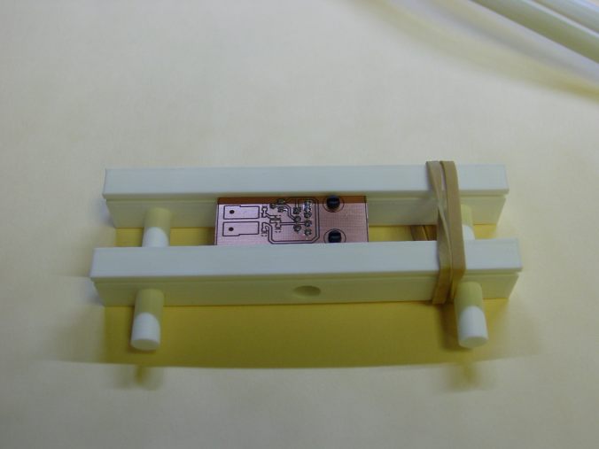 Low-Profile PCB holder(2 parts) oh and yeah a rubber band