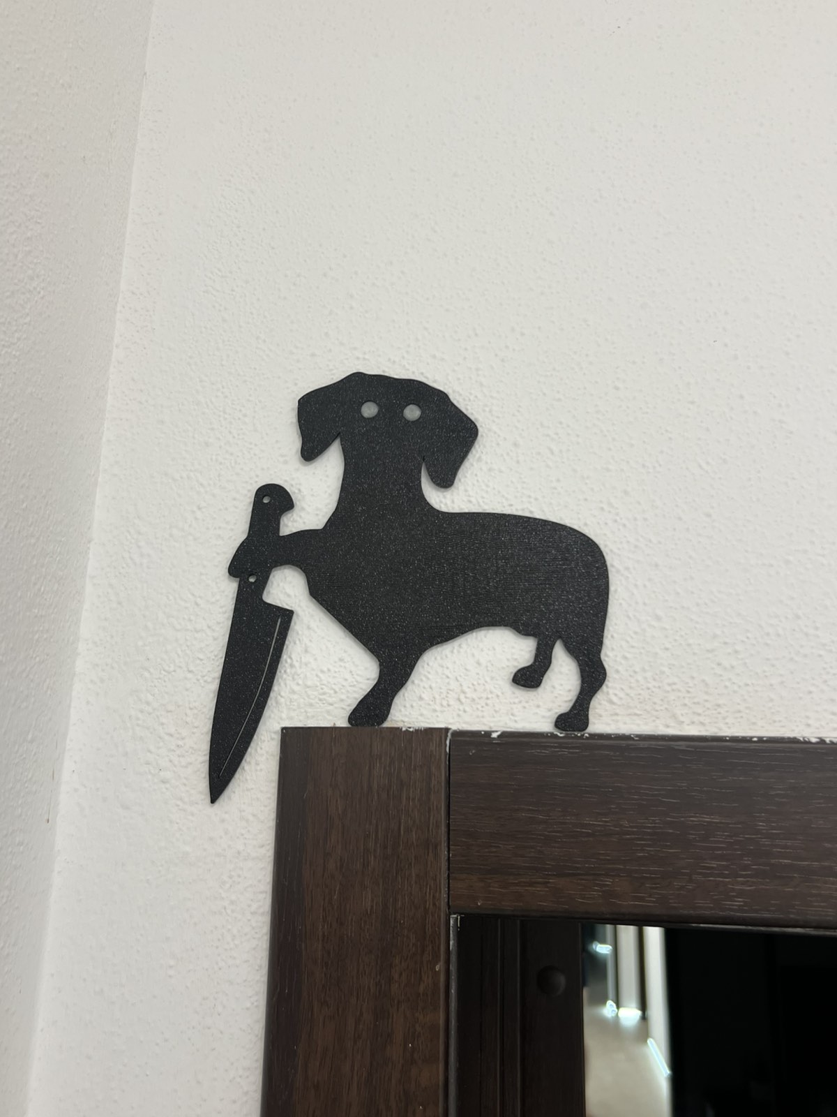 dachshund holding a knife