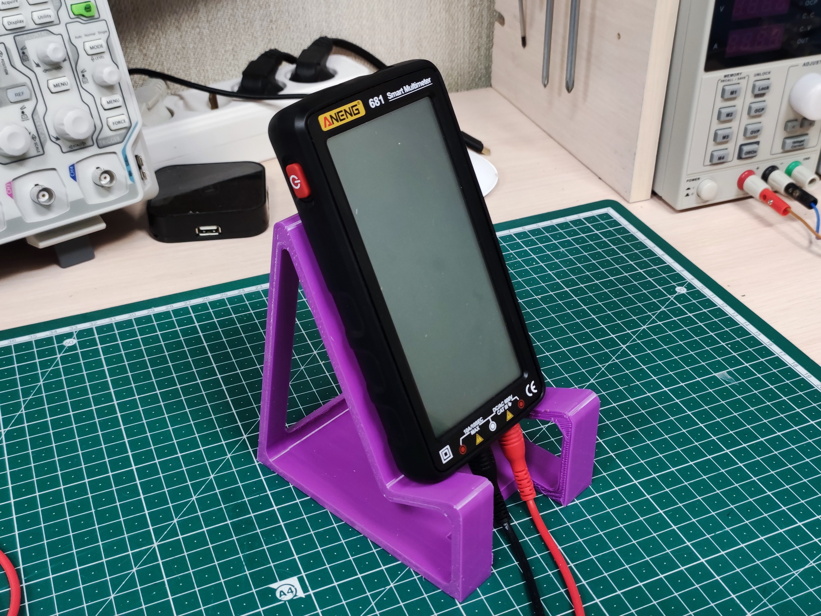 Universal multimeter and phone stand