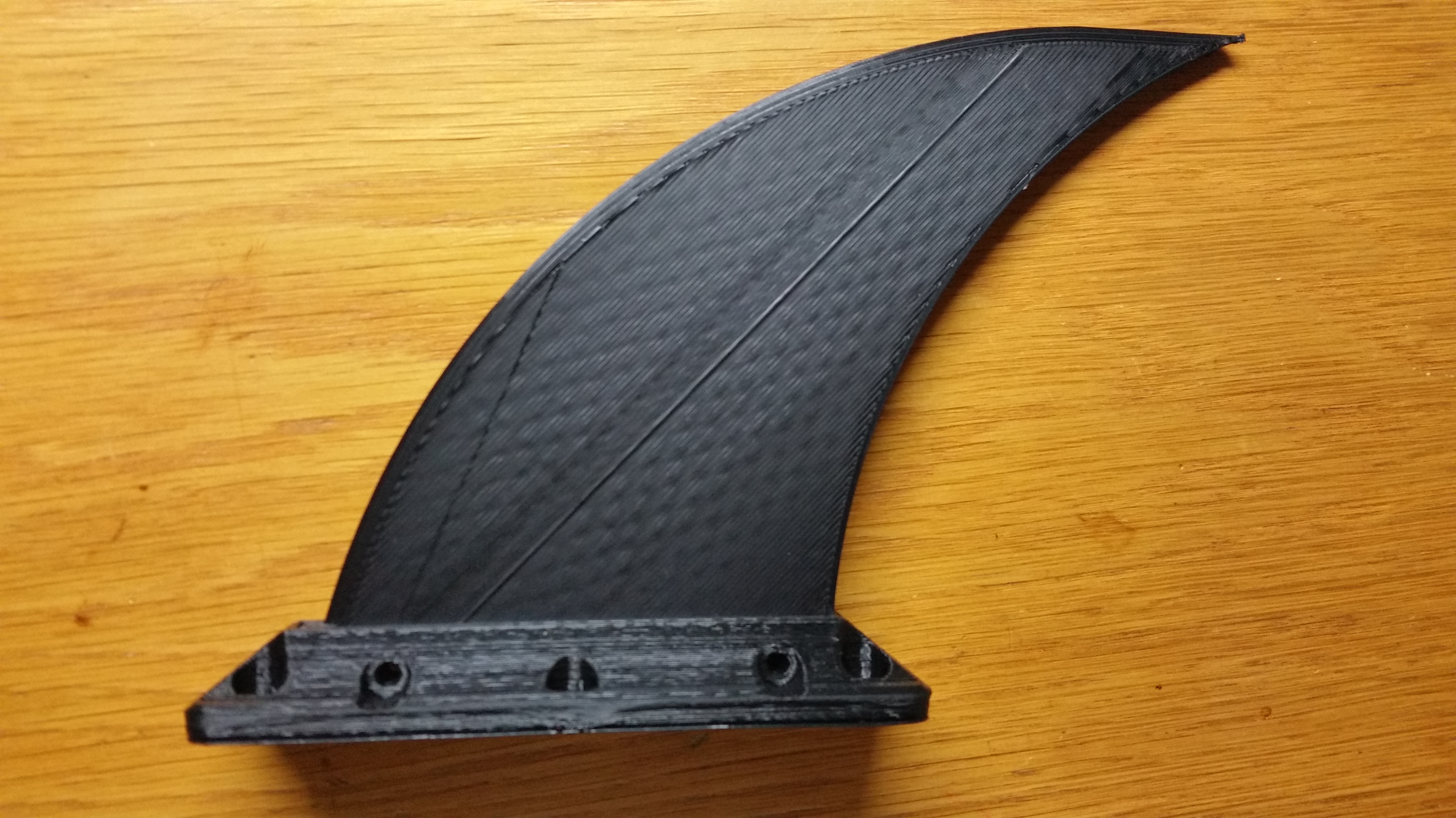 Skeg fin for Deflecting Debris around a hull mounted Bluerobotics T100 or T200 Thruster
