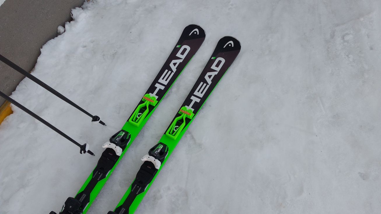 Mounting system for the ski and pole carrier handle