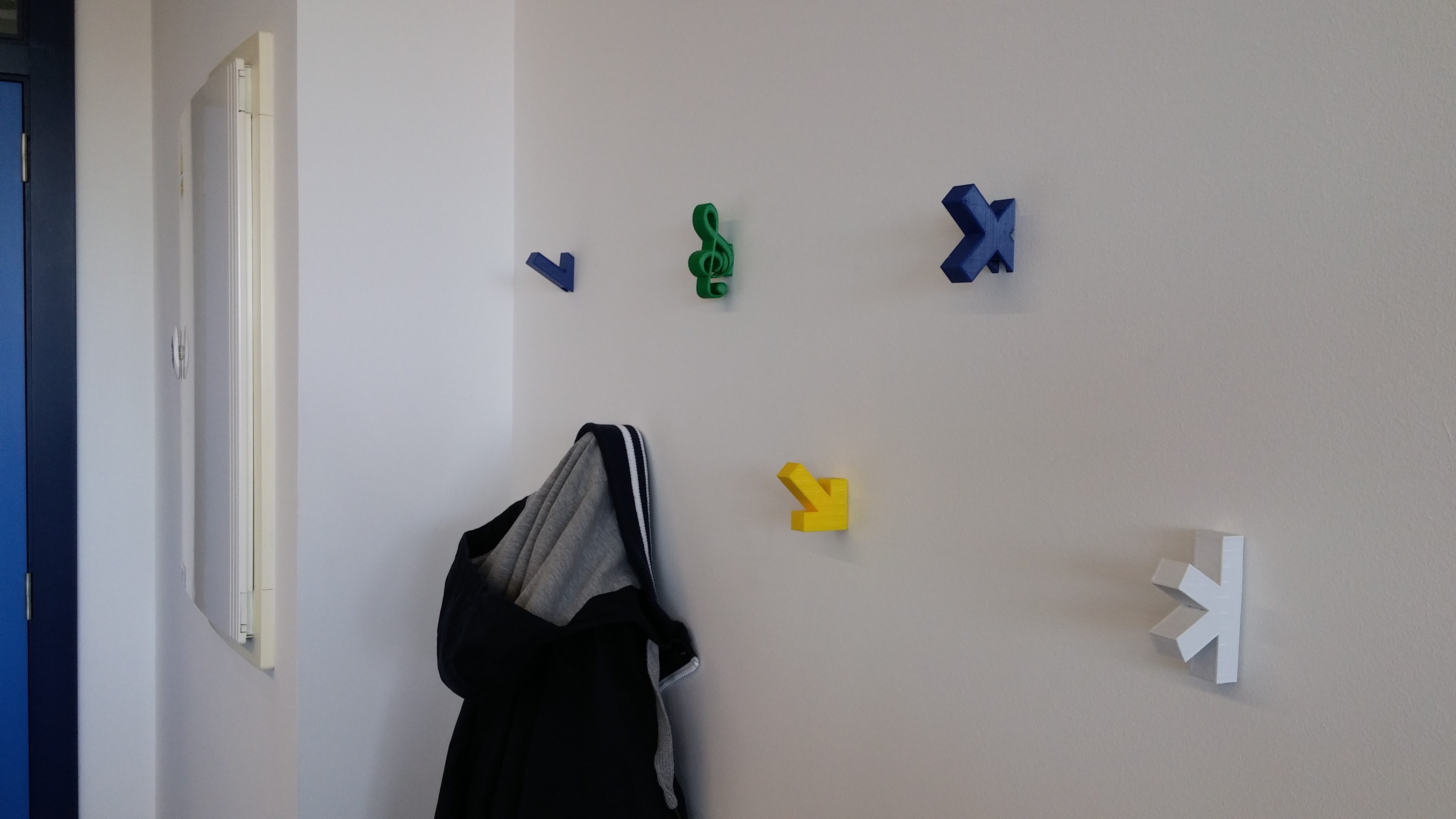 Interchangeable wall coat hook