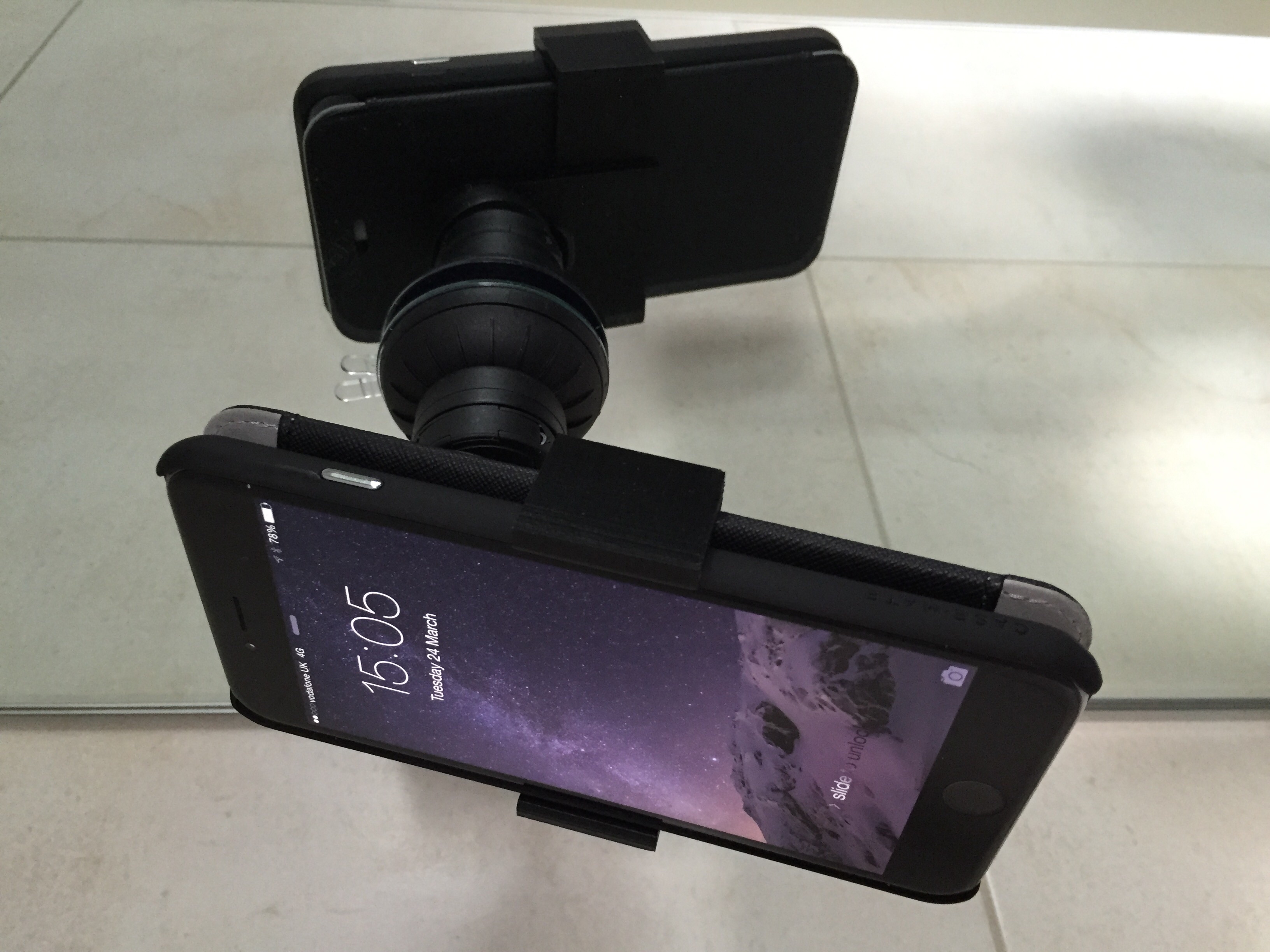Cased iPhone 6 Plus car mount adapter.