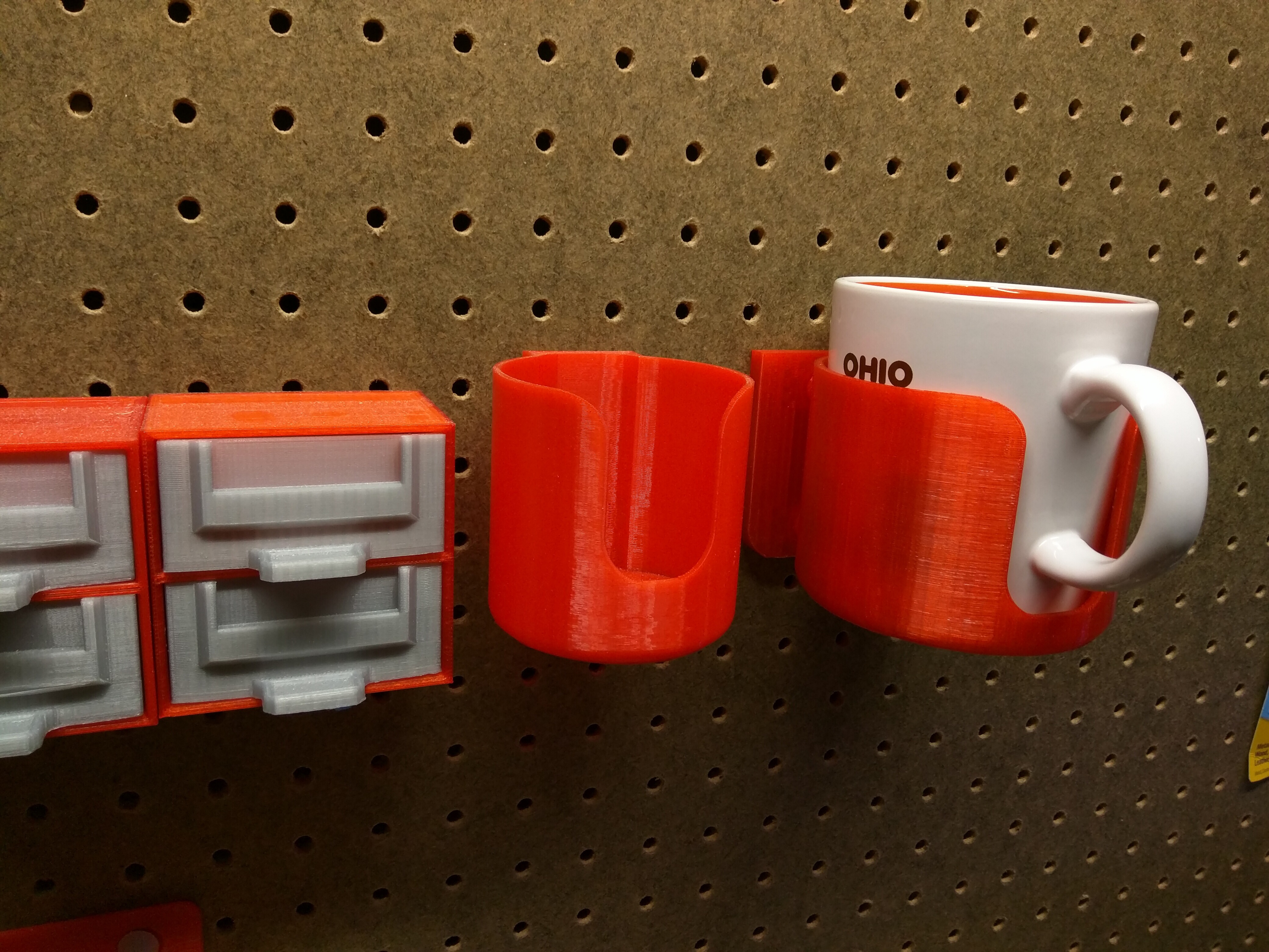 Pegboard mounted coffee cup holder