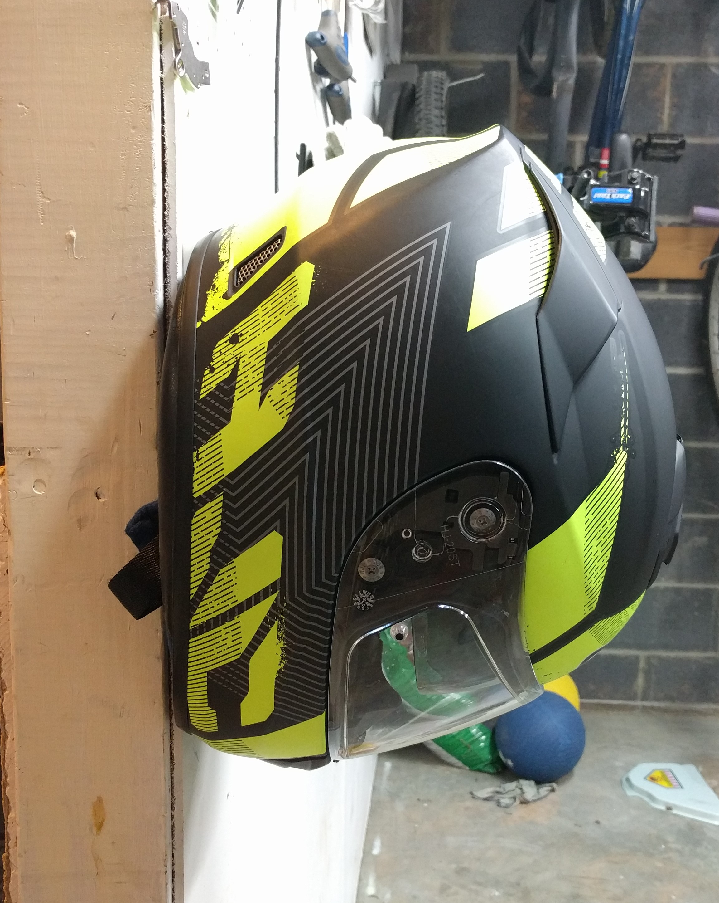 Wall mounted motorcycle helmet holder