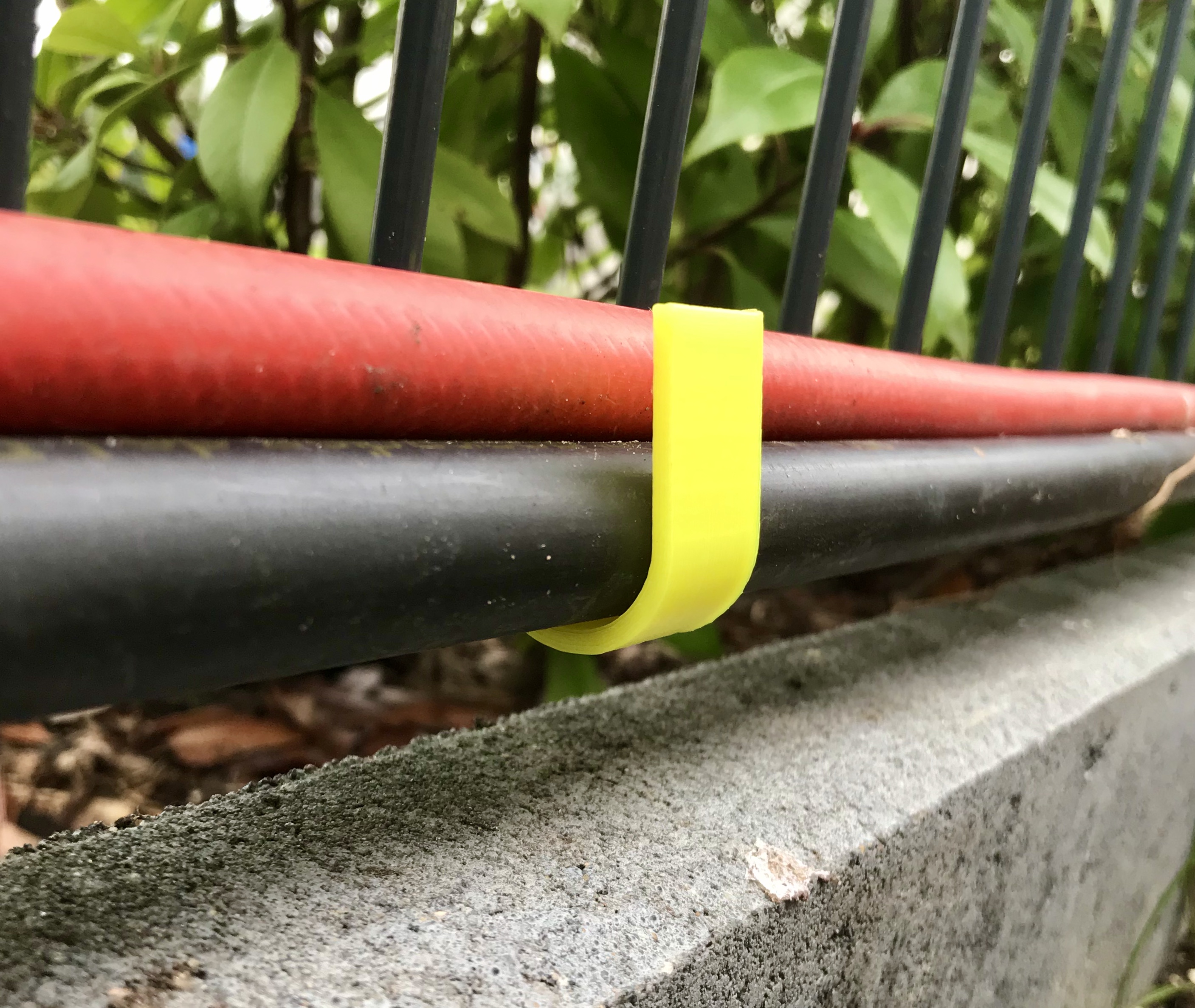 hose and pipe holder for double rod mat fences