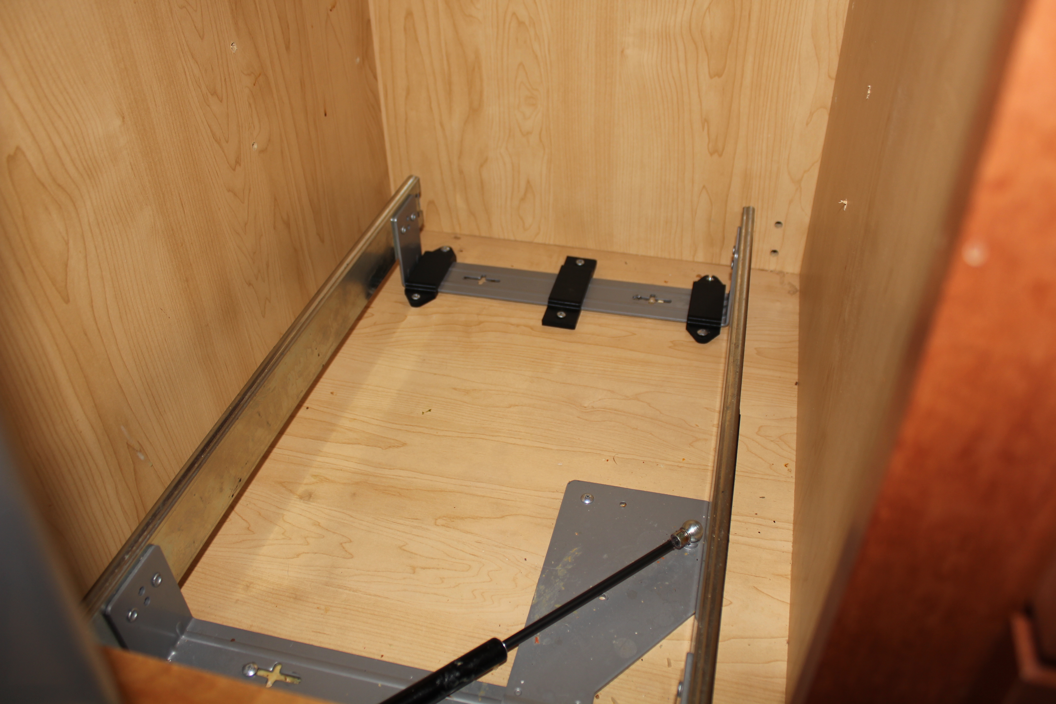Bracket for pullout garbage and recycling drawer