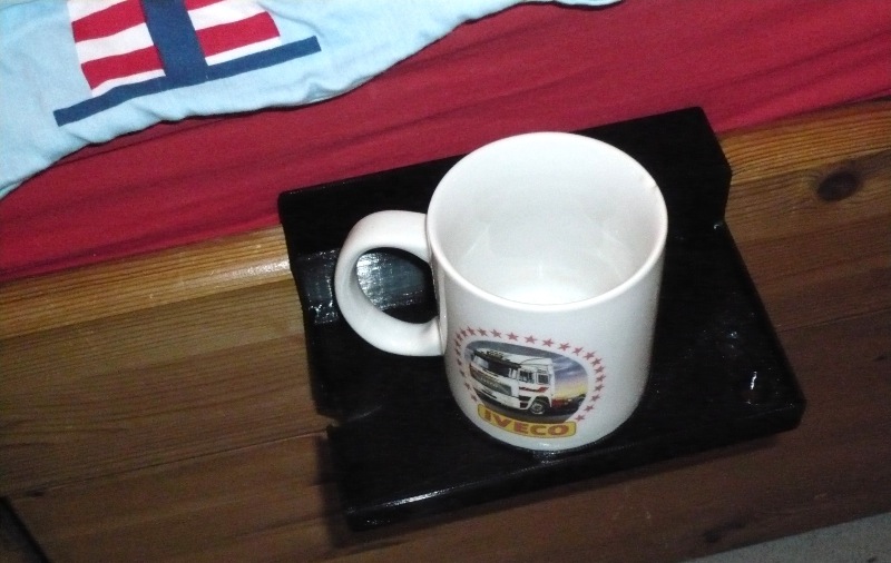 bedside holder supports two cup sizes and creative tools
