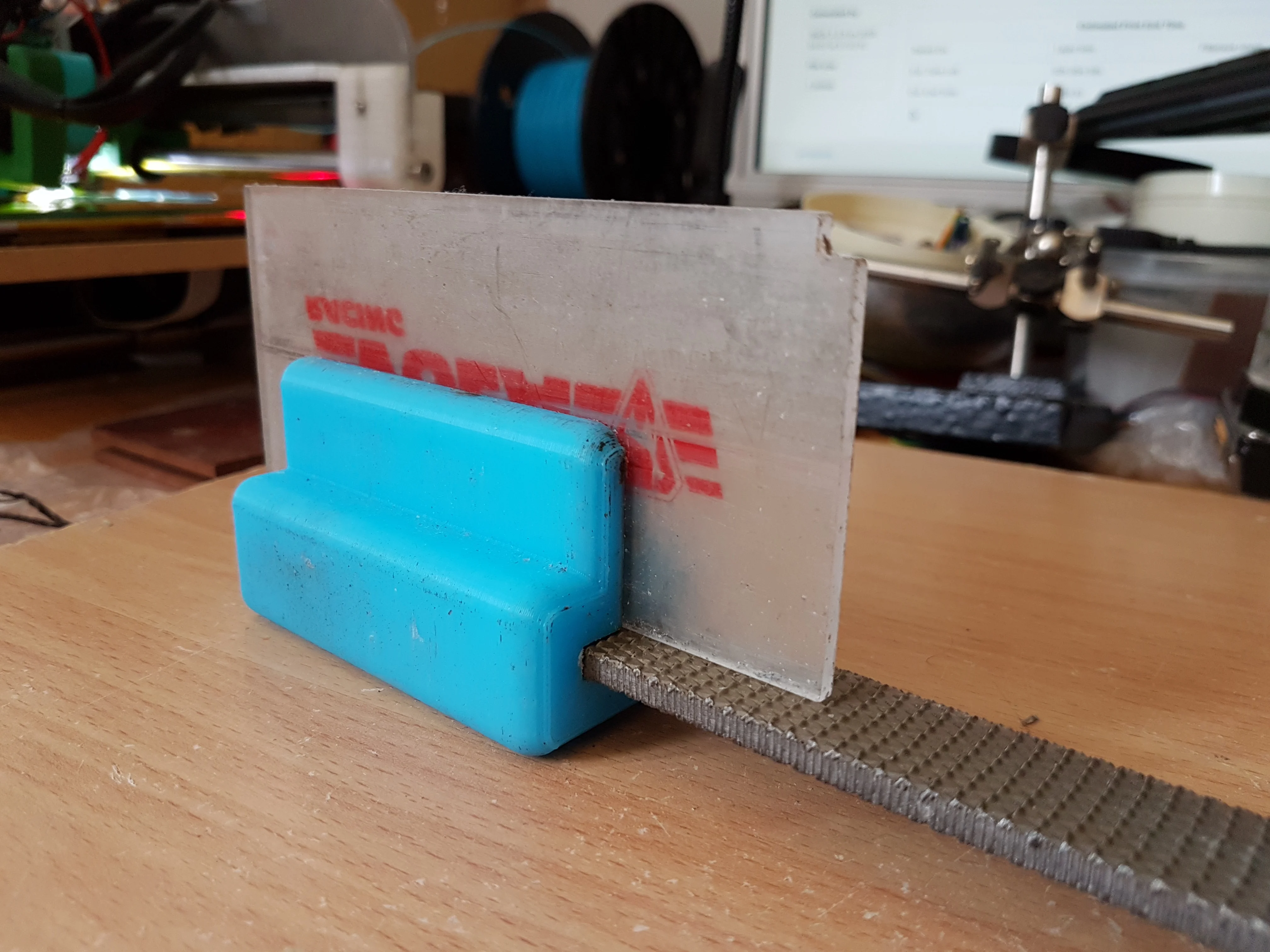 Ski wax scraper sharpener