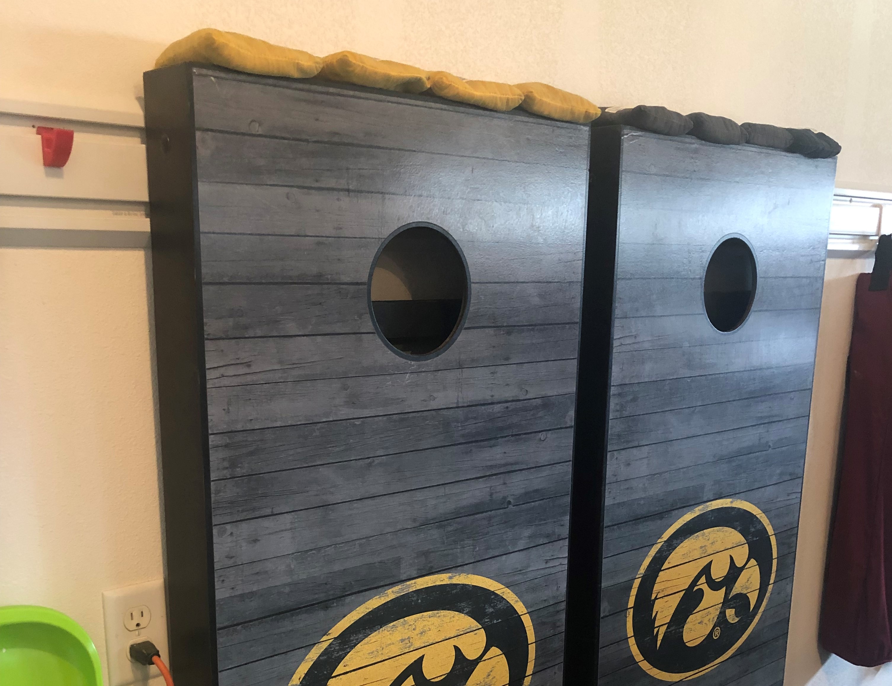 Cornhole board hanger for GearTrack