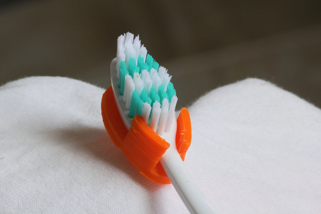 Wall mounted toothbrush holder