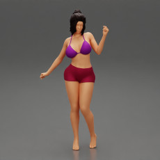young brunette woman in shorts and bra posing with short hair