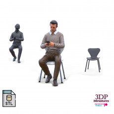 A Man sitting on a chair with smartphone