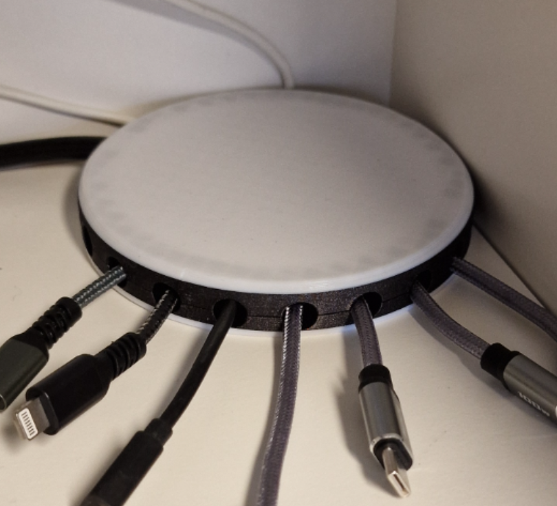 Round cover with organized outlets for cables