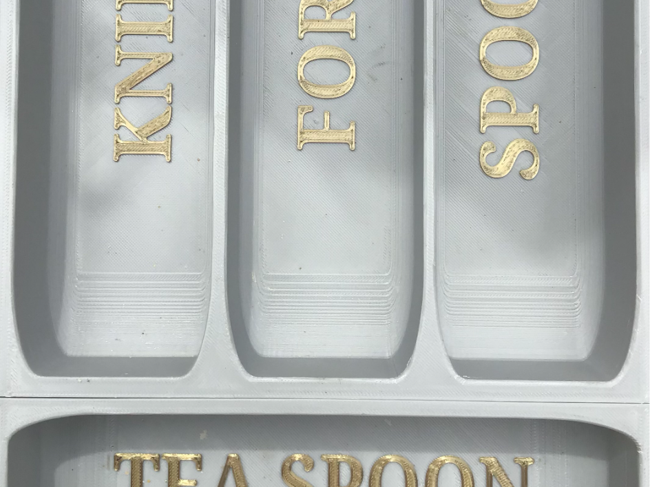 Labelled cutlery organiser.