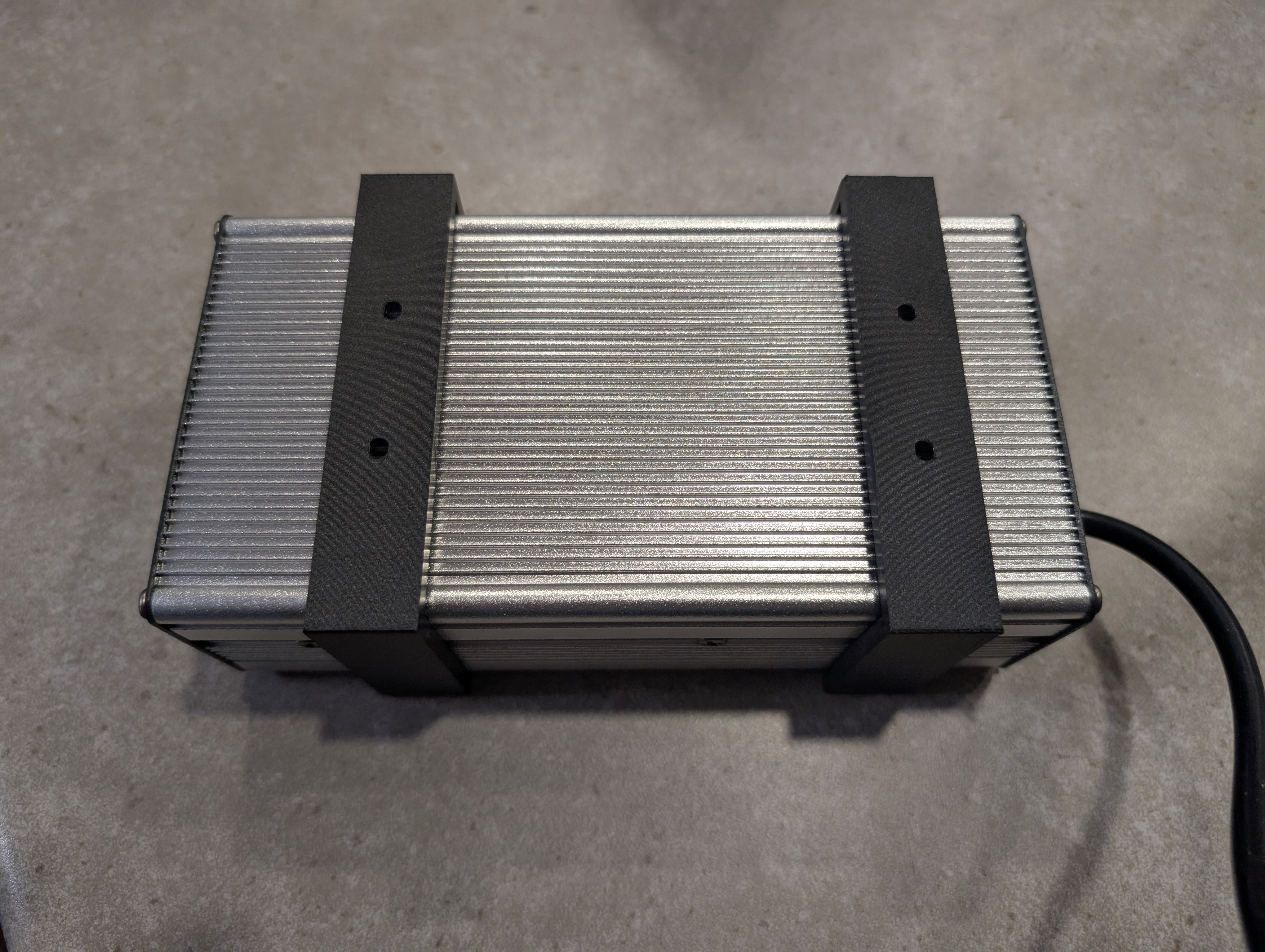 Customizable power adapter holder (OpenSCAD)