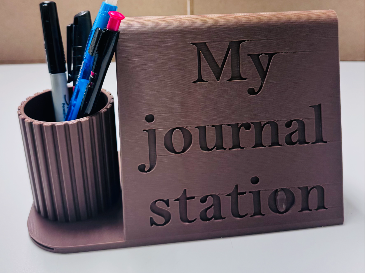 Journal station with pen holder