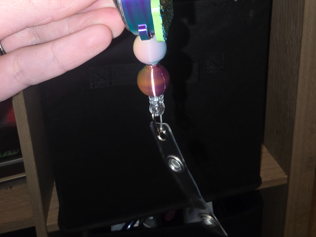 Badge reel beads