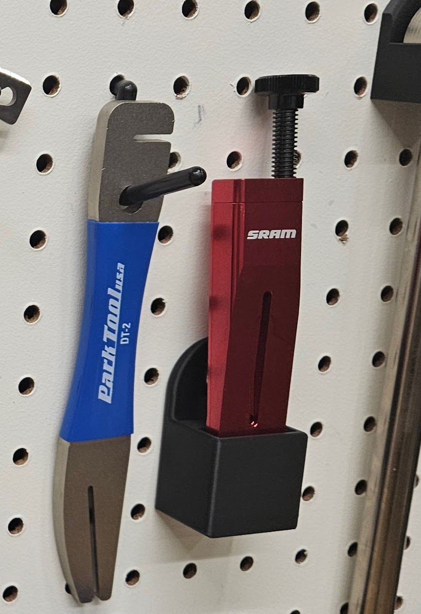 Pegboard holder for sram ultimate piston press