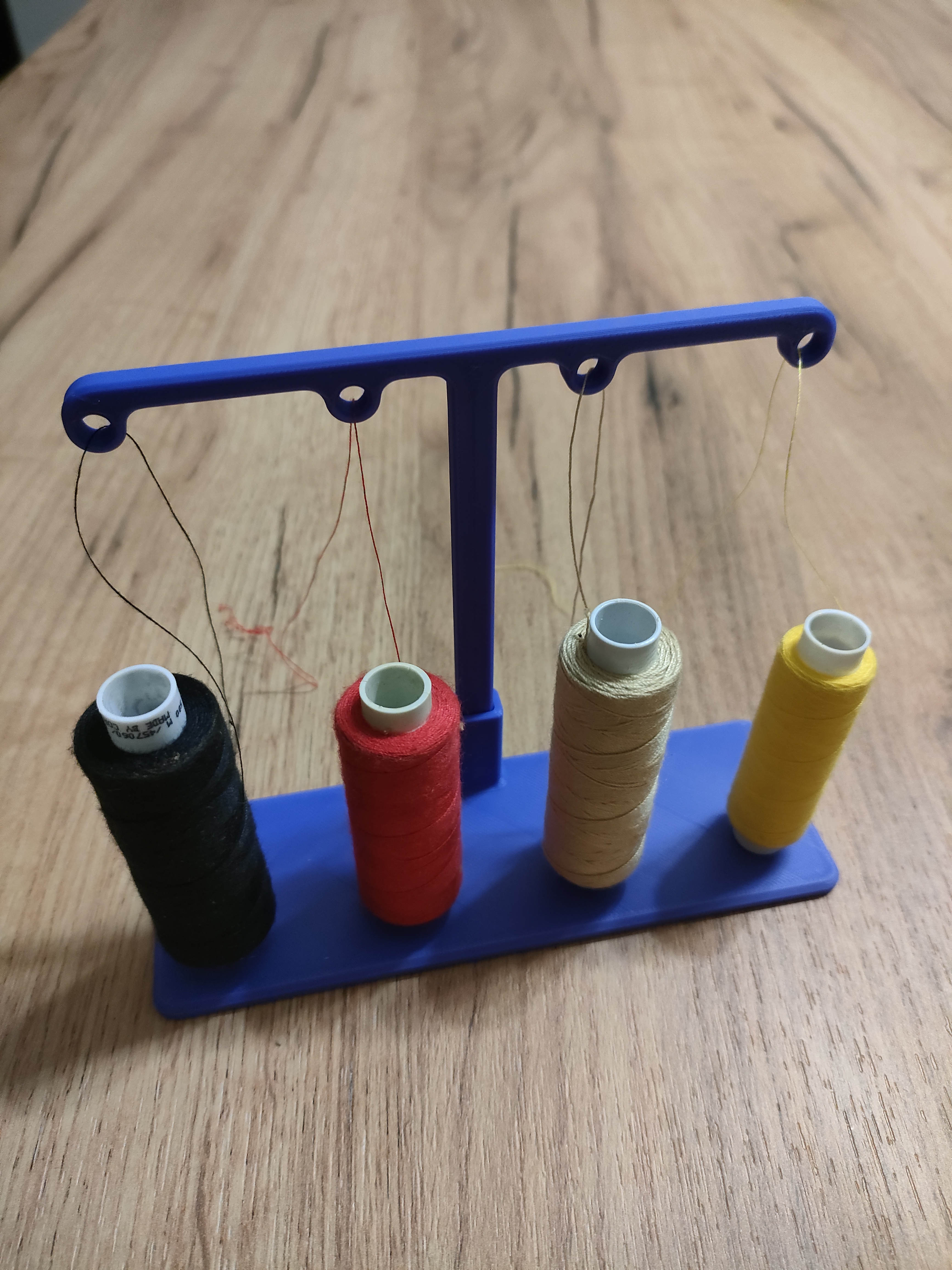 Thread guide for sewing machine for four spools