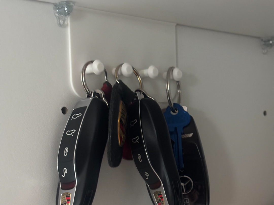Car key hanger under kitchen shelf