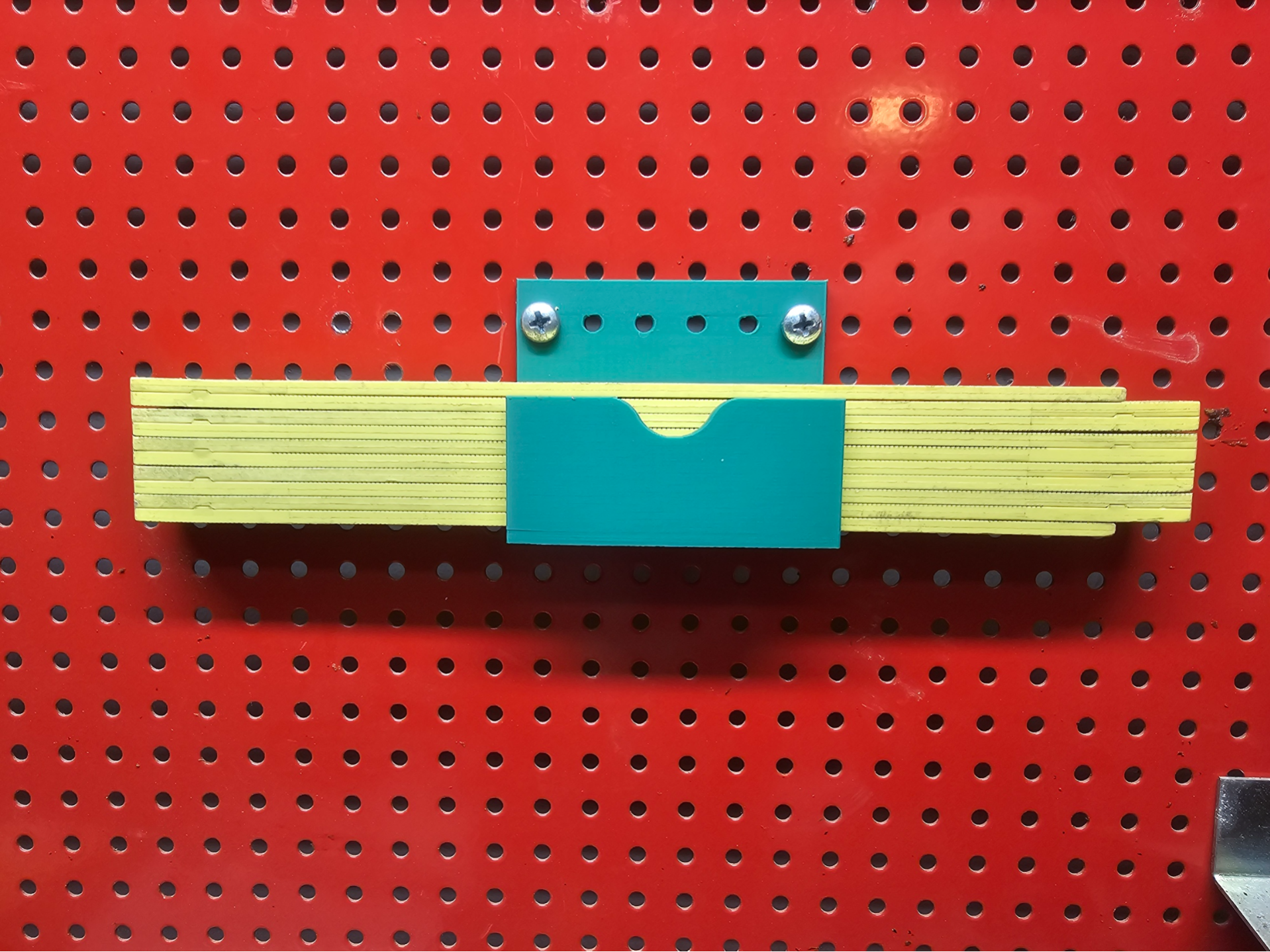 Folding rule holder for pegboard