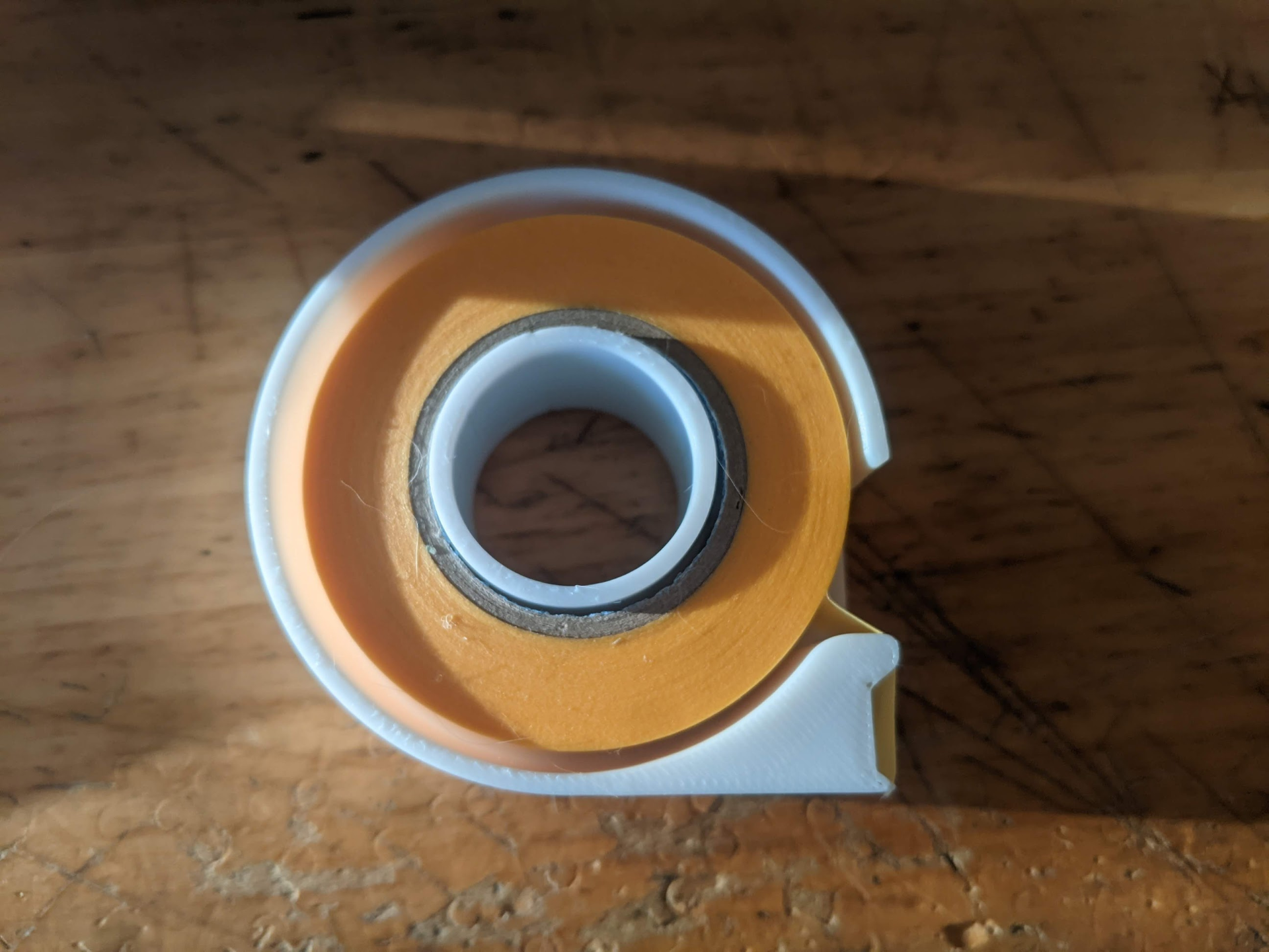 Compact masking tape dispenser