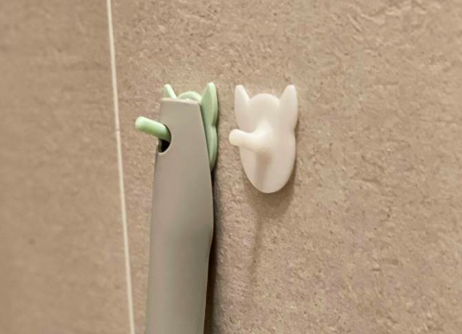PurrHook, the sleek cat-inspired scoop holder, for a clutter-free cat care corner.