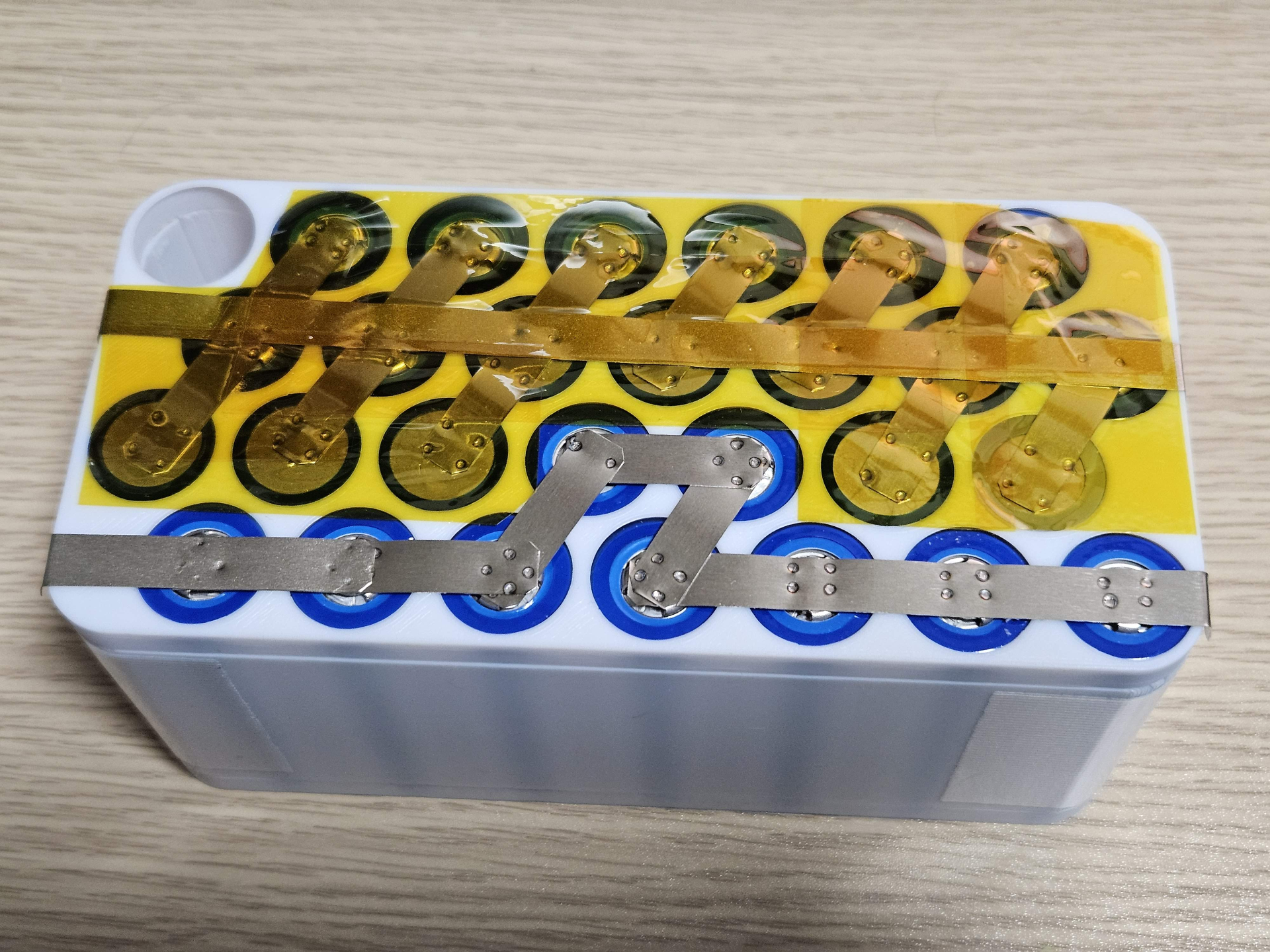 Space efficient parametric fit-all battery holder