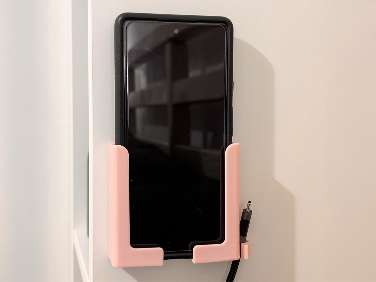 Wall mounted phone and cable holder