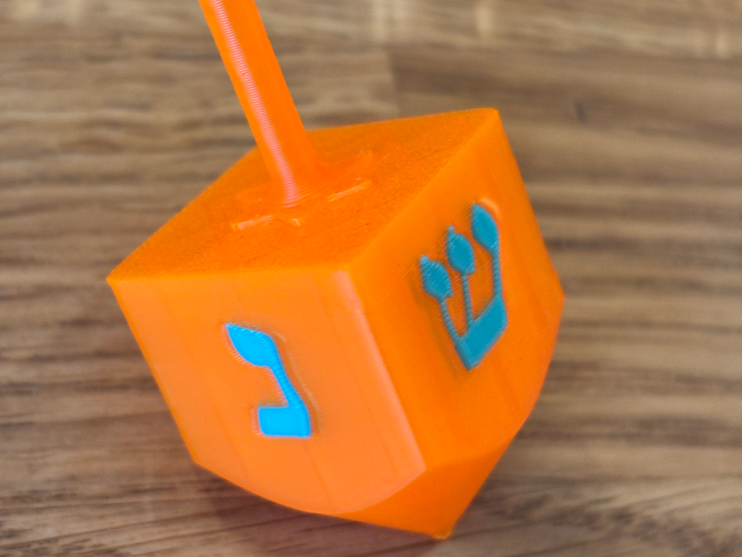 Chanukkah dreidel with colored letters