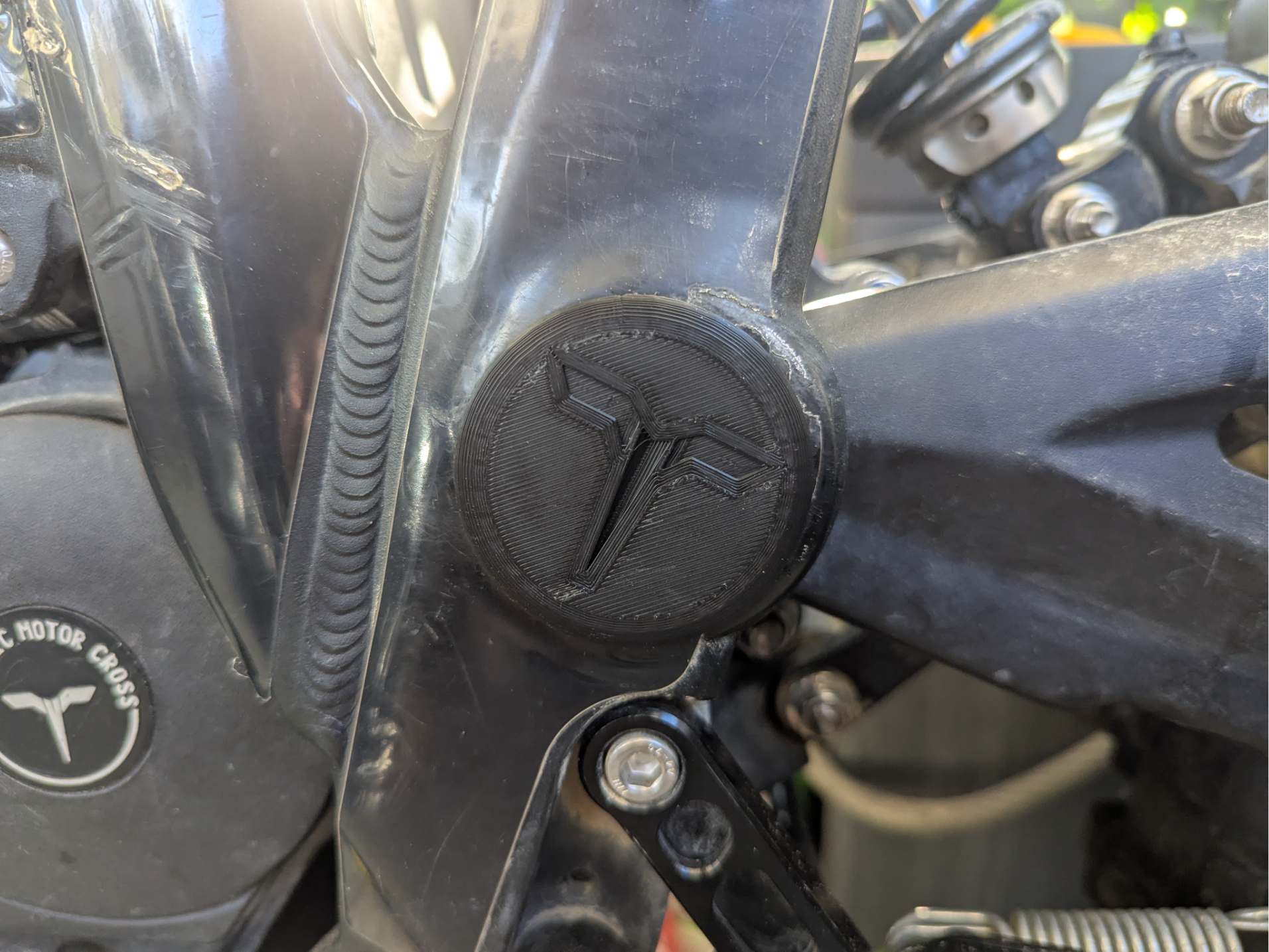 Cover for swingarm bolt Talaria Sting with logo