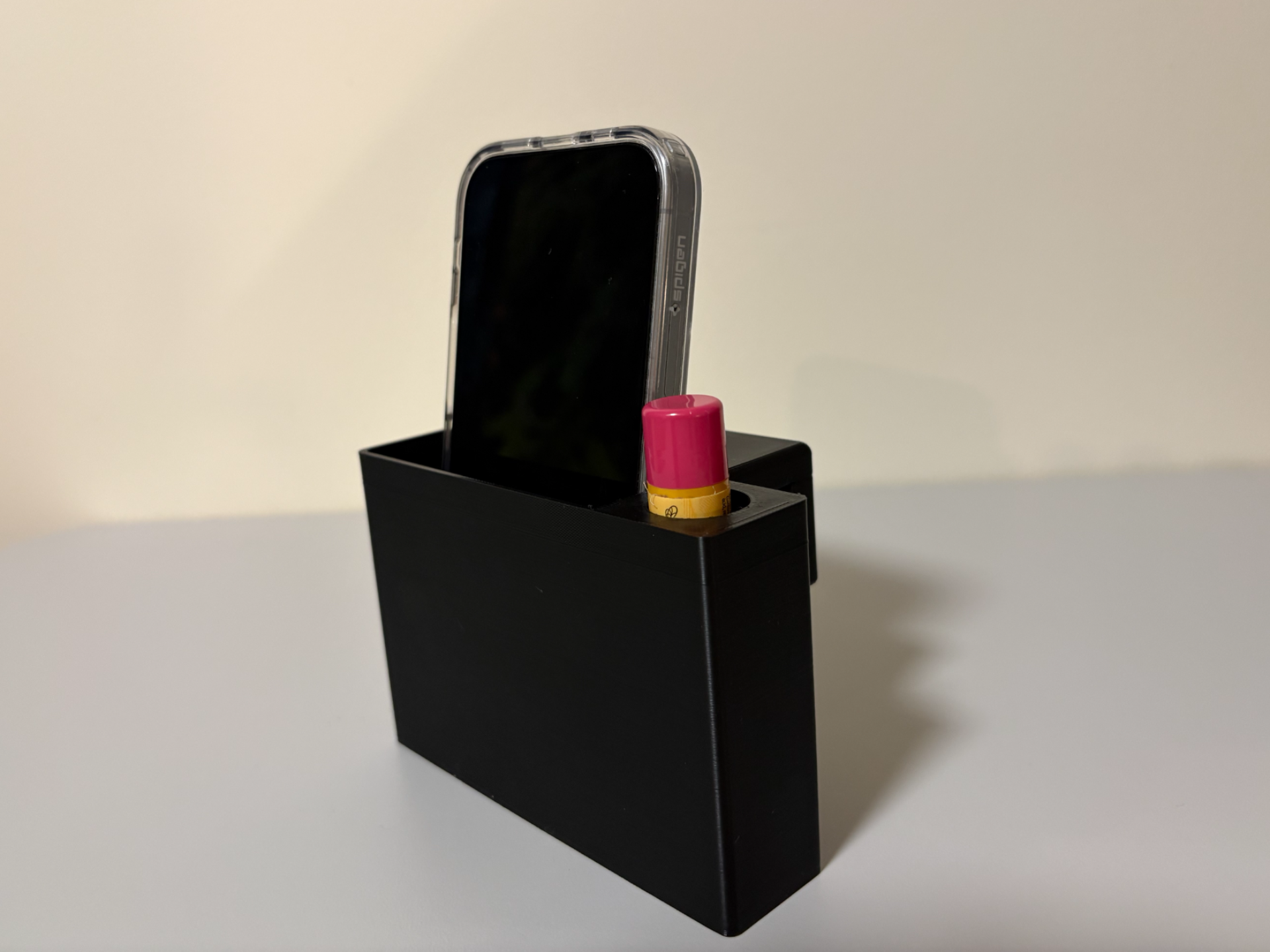 Bed frame phone and lip balm holder