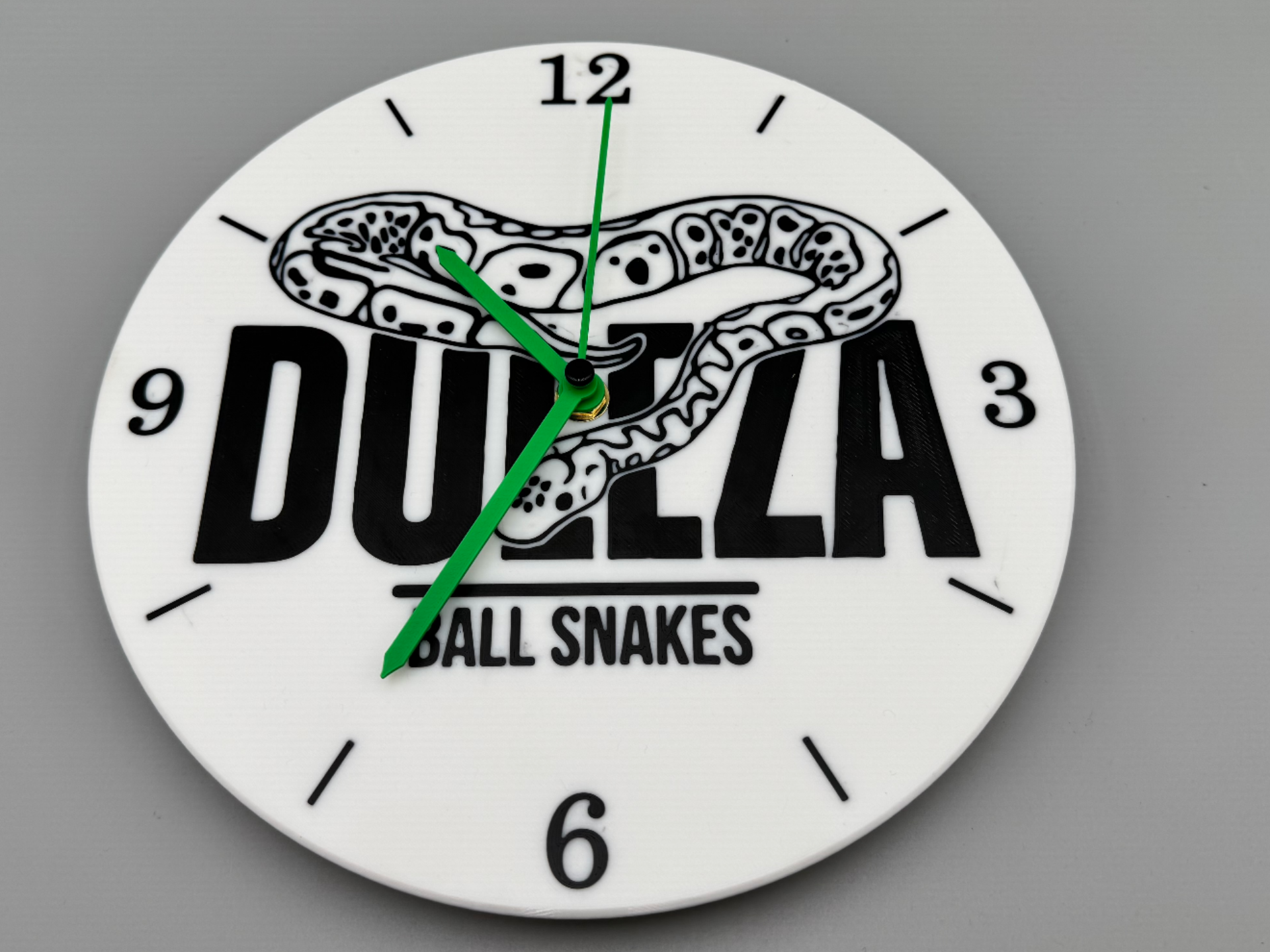 Wall clock with a ball python motif