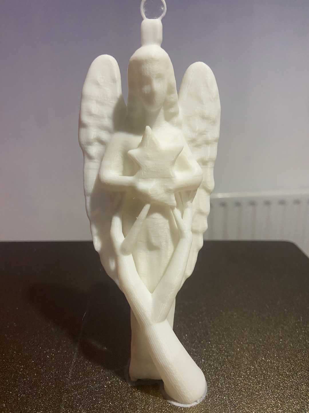 Angel holding a star Christmas tree decoration
