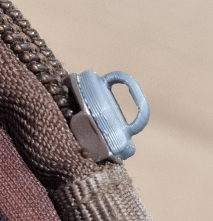 Zipper pull tab