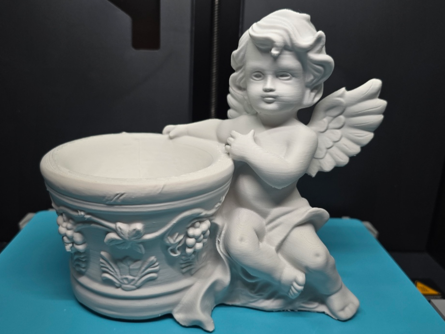 Decorated flower pot with cherub