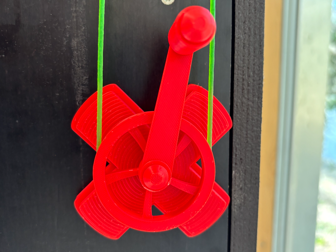 Turn handle for belt driven marble dispenser