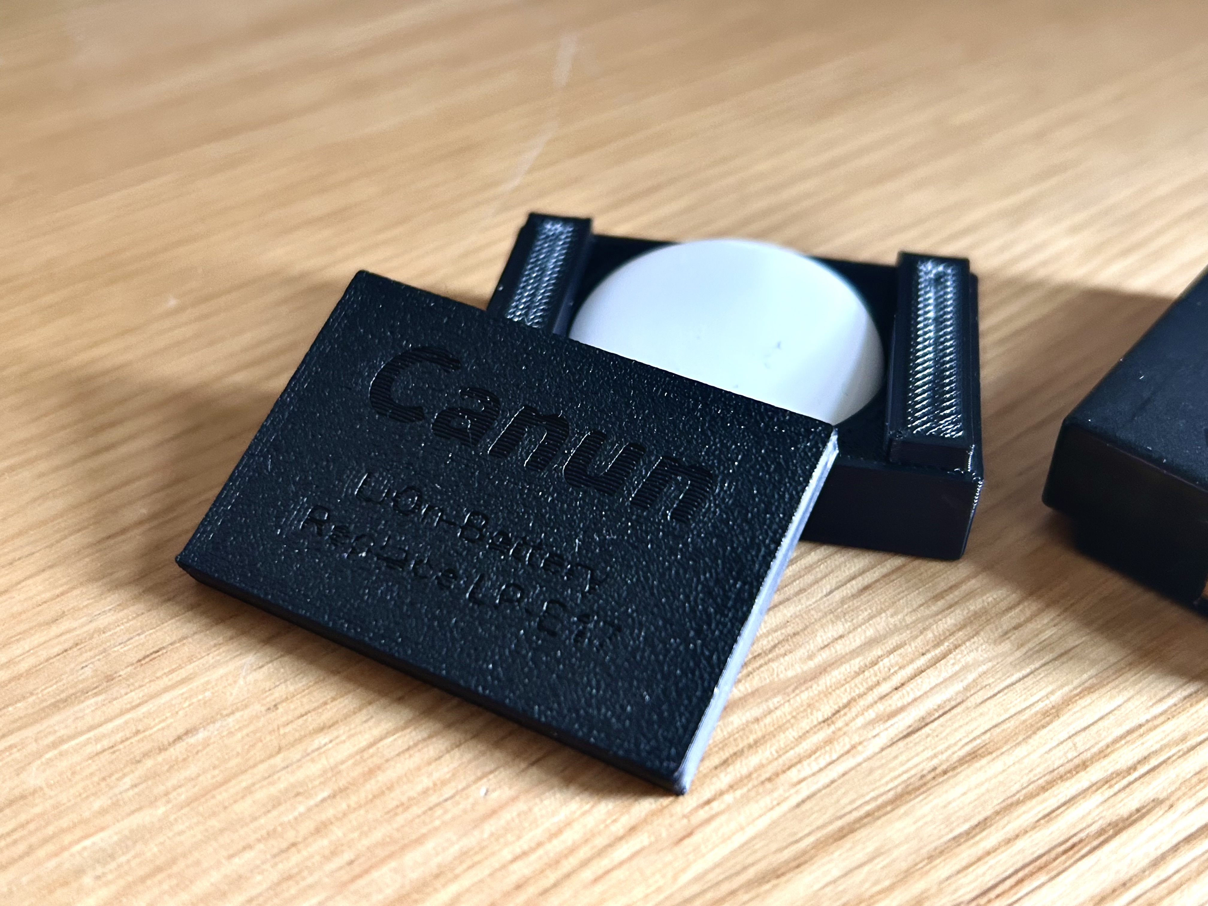 Canon LP-E17 dummy with Apple AirTag Integration