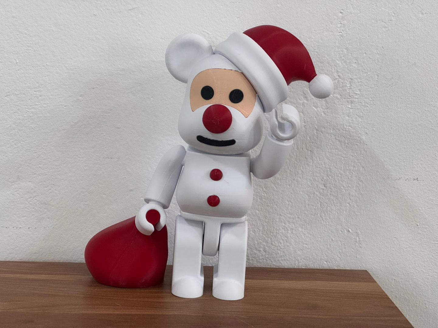 Santa Bearbrick holding a gift bag